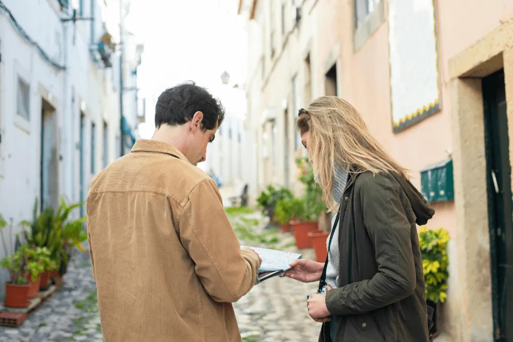 Two instructional designers exploring a new city environment while looking at a tablet together, representing the journey of discovering your ideal ID sector.